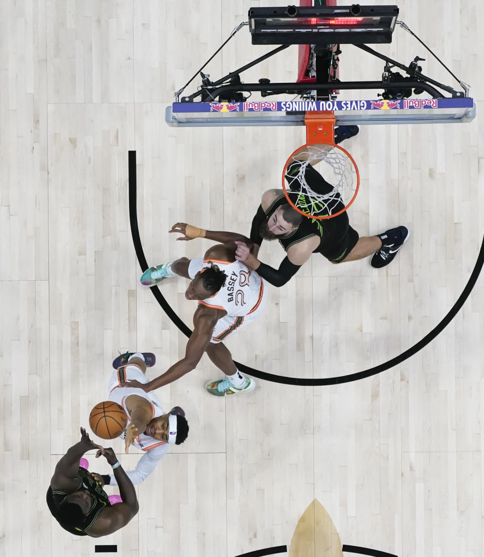 New Orleans Pelicans forward Zion Williamson (1) shoots against San Antonio Spurs forward Keldon Johnson and center Charles Bassey (28), as New Orleans Pelicans center Jonas Valanciunas (17) defends under the basket in the second half of an NBA basketball game in New Orleans, Friday, Dec. 1, 2023. The Pelicans won 121-106. (AP Photo/Gerald Herbert)