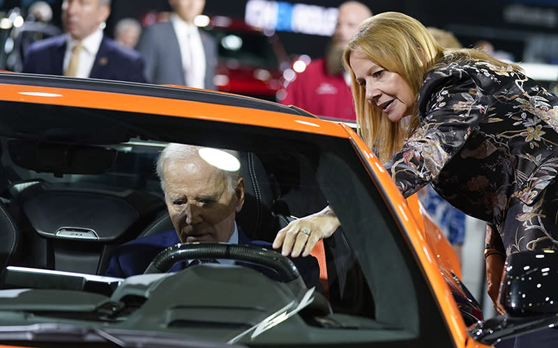 Mary Barra, CEO of General Motors, talks with President Biden