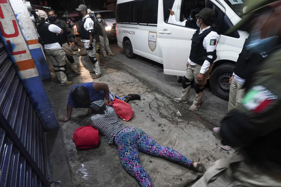 Mexican immigration agents detain a Haitian migrant who is part of a migrant caravan heading north in Huixtla, Chiapas state, Mexico, Sunday, Sept. 5, 2021. (AP Photo/Marco Ugarte)