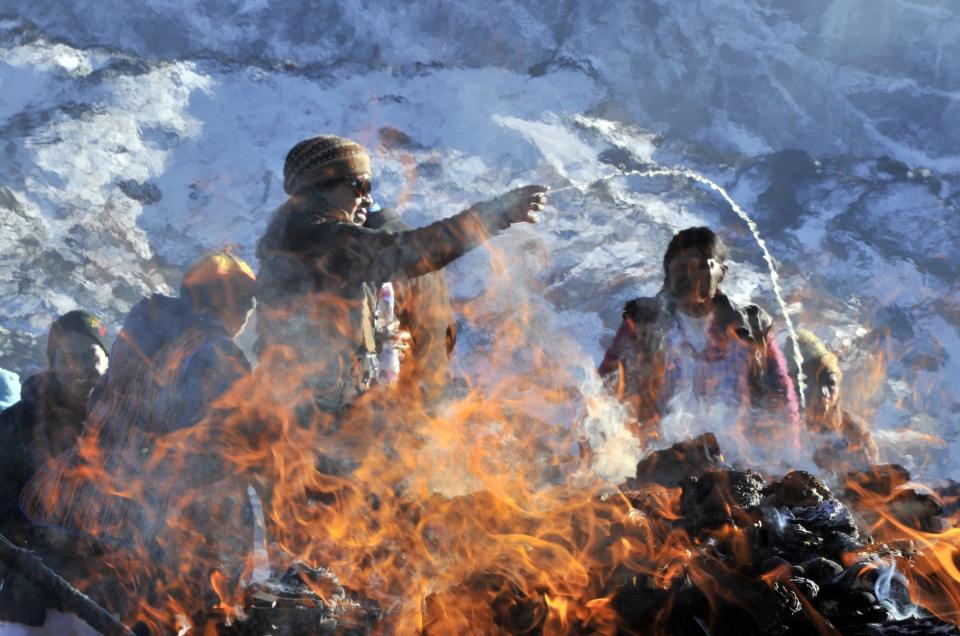 Aymara indigenous people perform a ritual to the Pachamama (Mother Earth) on August 1, 2014 in La Cumbre, 25 km from La Paz. Bolivians will pay homage to the Pachamama during August. AFP PHOTO/Aizar Raldes        (Photo credit should read AIZAR RALDES/AFP/Getty Images)