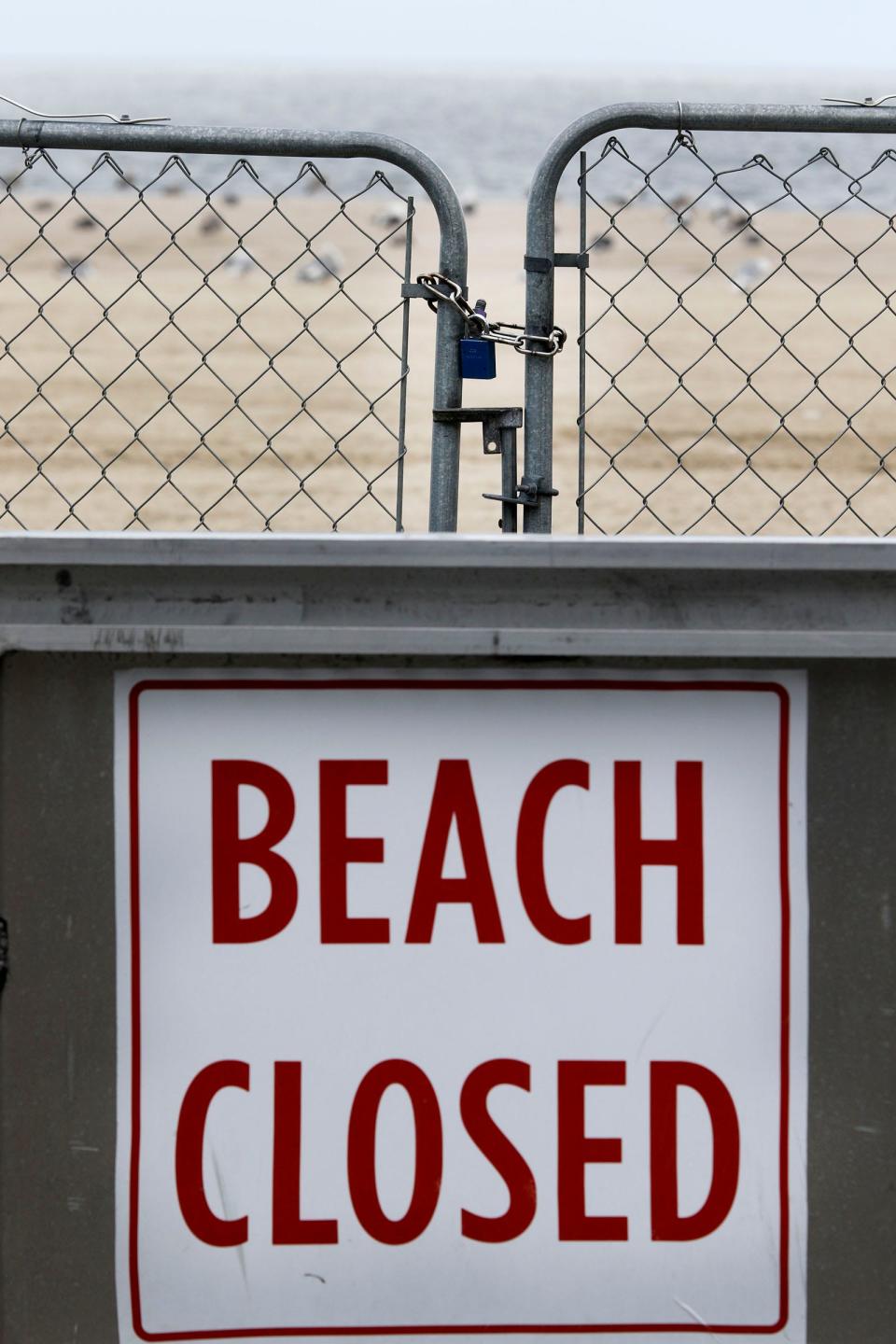 A "Beach Closed" sign and padlocked fence on the Point Pleasant Beach boardwalk near Arnold Avenue in the town Wednesday afternoon, September 13, 2023.