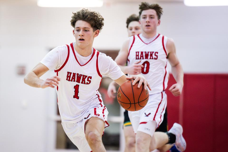 Hudson's Jake Attaway drives versus Clinton High on Friday January 12, 2024.