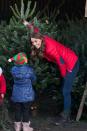 <p>The duchess helps a child pick out a Christmas tree at a Family Action charity event.</p>