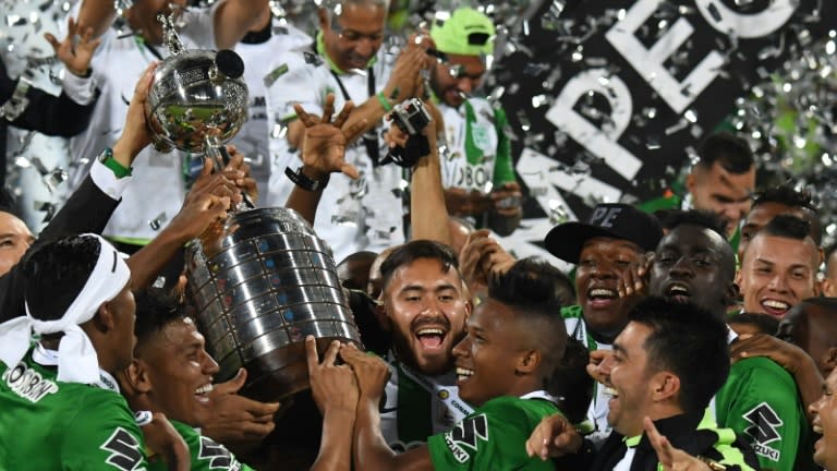 Colombia's Atletico Nacional players celebrate with the trophy after winning the 2016 Copa Libertadores at Atanasio Girardot stadium