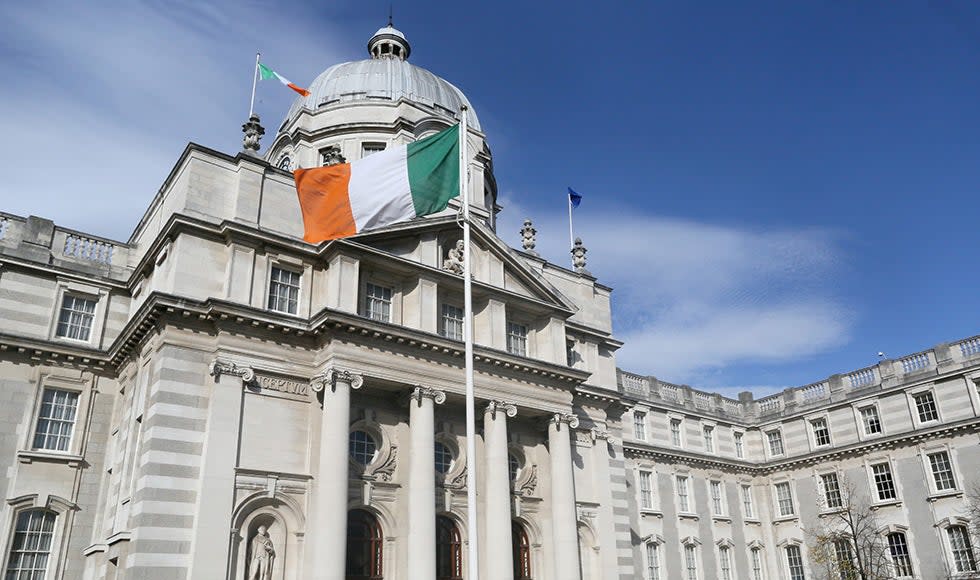 An Irish national flag flies in front of the Government Buildings in Dublin, Ireland