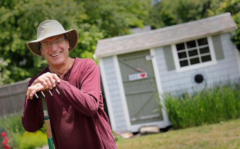 Retired Braintree social studies teacher Larry Kramer, of Scituate, keeps busy in his garden on Friday, June 23, 2023.