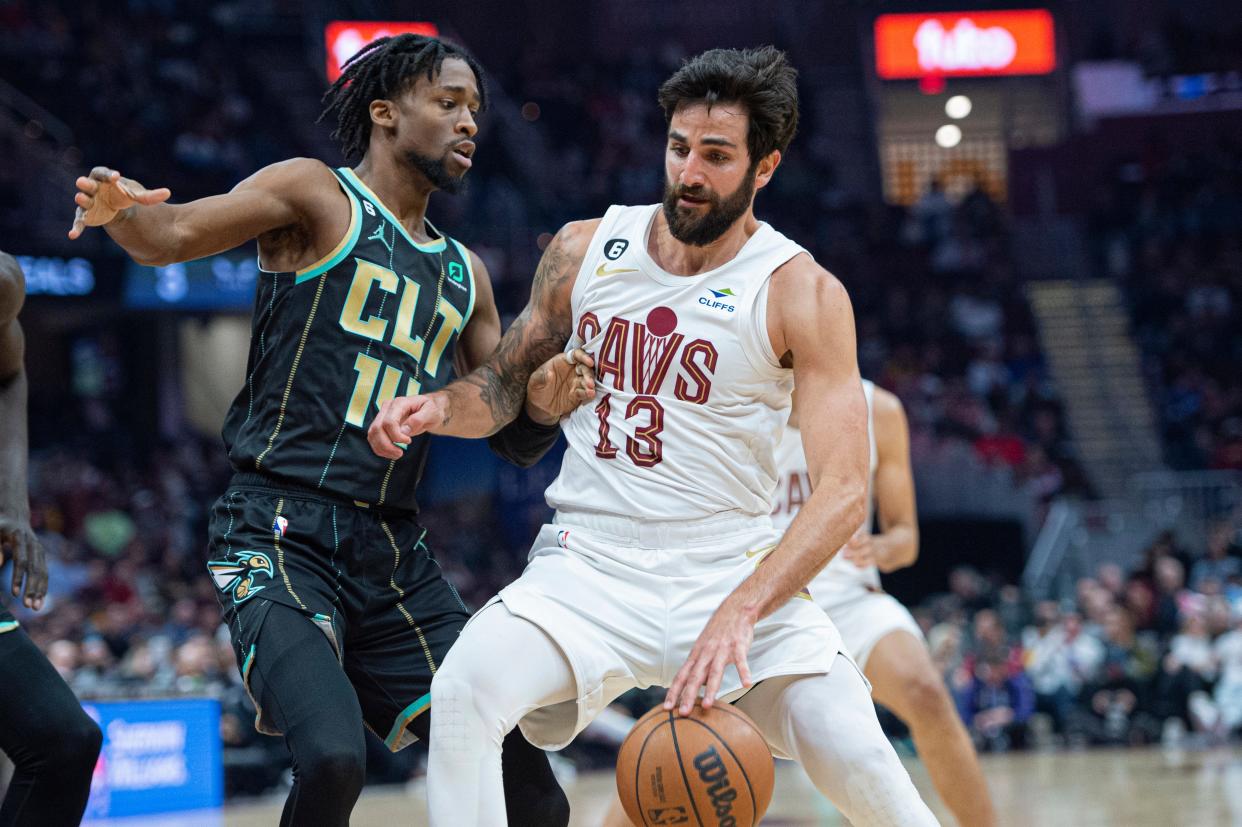 Cleveland Cavaliers' Ricky Rubio (13) drives to the basket as Kobi Simmons (14) defends during the first half of an NBA basketball game in Cleveland, Sunday, April 9, 2023. (AP Photo/Phil Long)