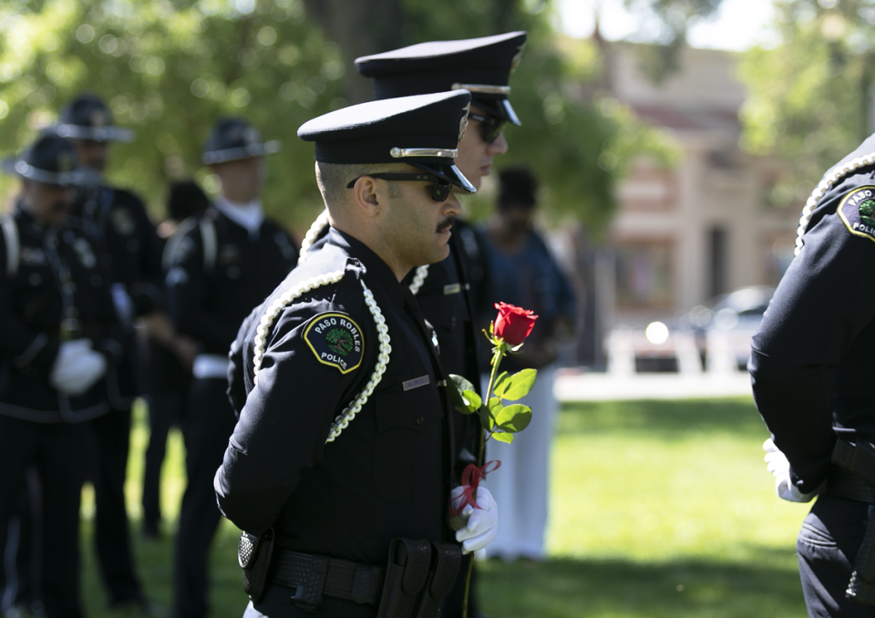 The Peace Officers’ Memorial was held at the Paso Robles Downtown City Park on Wednesday, May 17, 2023. Paso Robles police Officer Michael Ortiz holds a rose.
