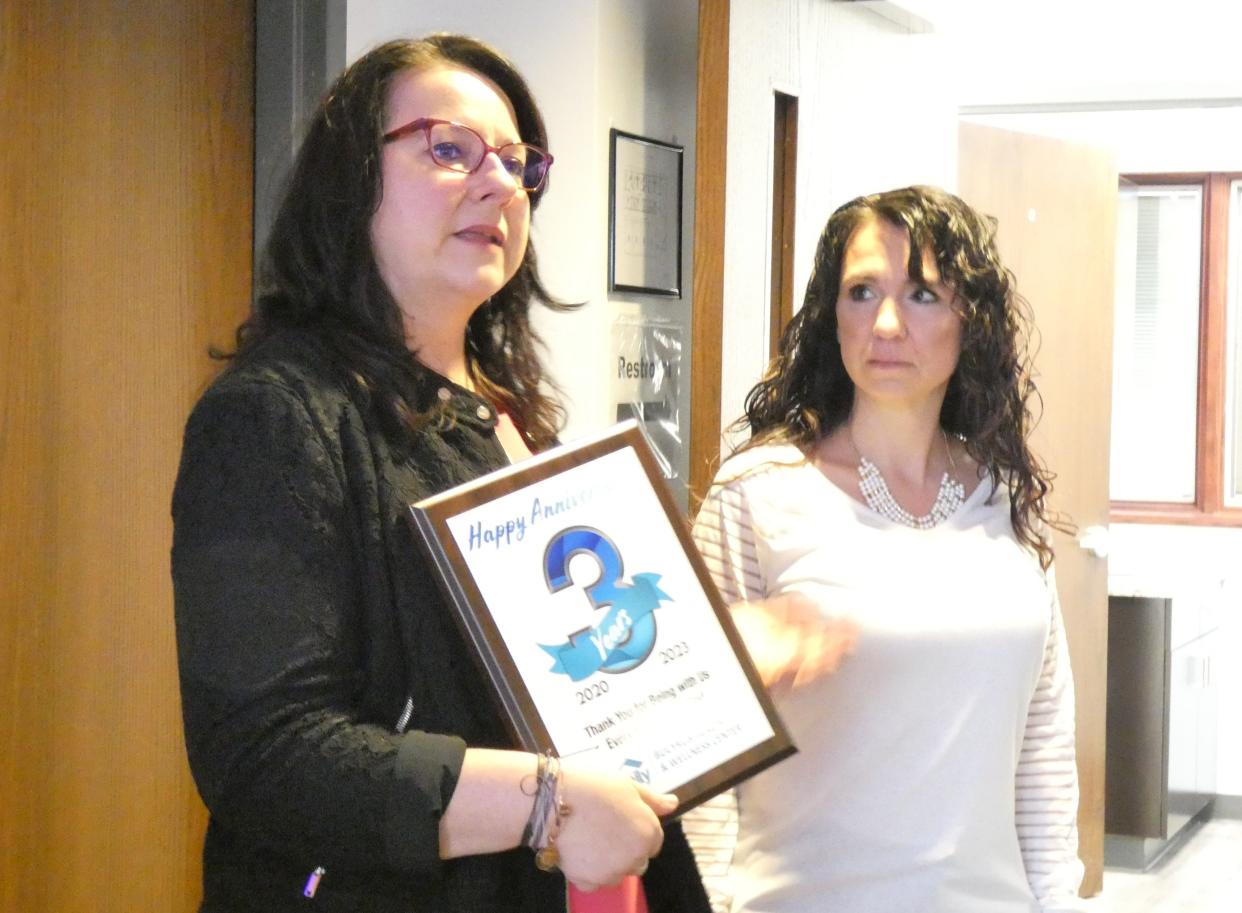 Peggy Anderson, chief executive officer at Third Street Family Health Services, presents a plaque honoring Bucyrus Health and Wellness Center’s third anniversary to Cindy Viers, nurse practitioner.