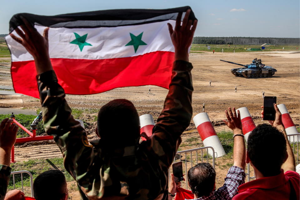 <p>Syrian military officers support their team during an individual race in Stage 1 of the Tank Biathlon Contest at the 2018 International Army Games in Alabino, Moscow region, Russia on July 31, 2018. (Photo: Sergei Bobylev/TASS via Getty Images) </p>