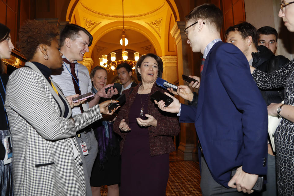 Sen. Amy Klobuchar, D-Minn., center, talks to reporters as she arrives at the Capitol in Washington, Wednesday, Jan. 22, 2020. The U.S. Senate plunges into President Donald Trump's impeachment trial with Republicans abruptly abandoning plans to cram opening arguments into two days but solidly rejecting for now Democratic demands for more witnesses to expose what they deem Trump's "trifecta" of offenses. Trump himself claims he wants top aides to testify, but qualified that by suggesting there were "national security" concerns to allowing their testimony. (AP Photo/Julio Cortez)