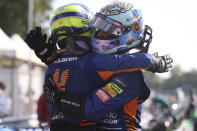 Mclaren driver Daniel Ricciardo of Australia, right, celebrates after with second placed Mclaren driver Lando Norris of Britain after winning the Italian Formula One Grand Prix, at Monza racetrack, in Monza, Italy, Sunday, Sept.12, 2021. (Lars Baron/Pool via AP)