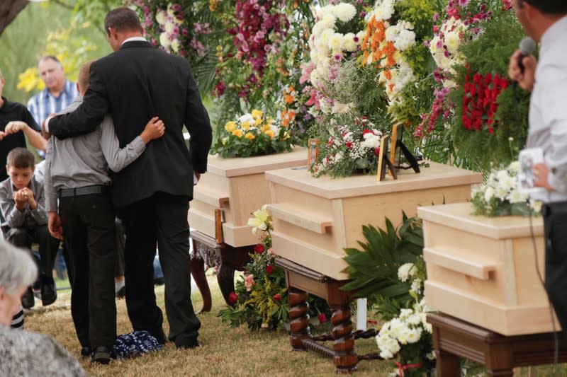 Relatives embrace during the funeral service of Dawna Ray Langford and her sons Trevor, Rogan, who were killed by unknown assailants, to be buried at the cemetery in La Mora