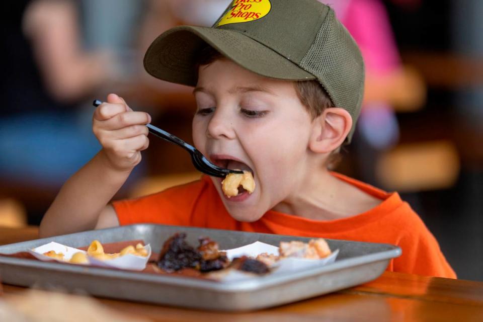 Mason Hicks savors some Mac ’N’ Cheese from Prime Barbecue on Friday, August 18, 2023 in Knightdale, N.C. 