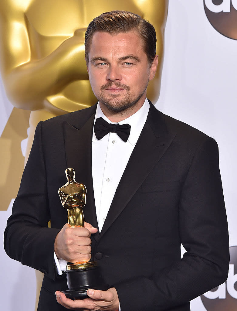 Leonardo DiCaprio holding an Oscar