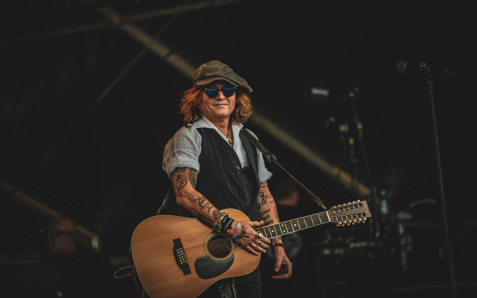 HELSINKI, FINLAND - JUNE 19: Johnny Depp performs on stage with Jeff Beck (not pictured) during the Helsinki Blues Festival at Kaisaniemen Puisto on June 19, 2022 in Helsinki, Finland. (Photo by Venla Shalin/Redferns)