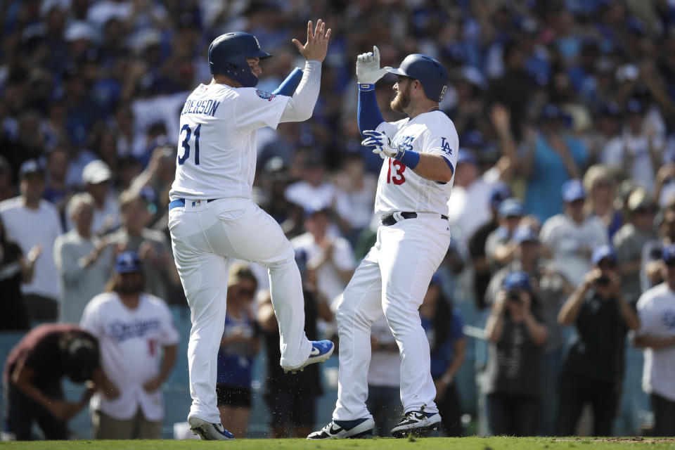 Los Angeles Dodgers' Max Muncy, right, celebrates his two-run home run with Joc Pederson during the fifth inning of a tiebreaker baseball game against the Colorado Rockies, Monday, Oct. 1, 2018, in Los Angeles. (AP Photo/Jae C. Hong)