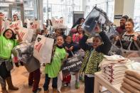 <p>A group of kids cheer as they complete their H&M shopping spree, courtesy of GLAM4GOOD, a charity dedicated to providing clothing to the disadvantaged youth in Detroit, Michigan on December 16, 2019.</p>
