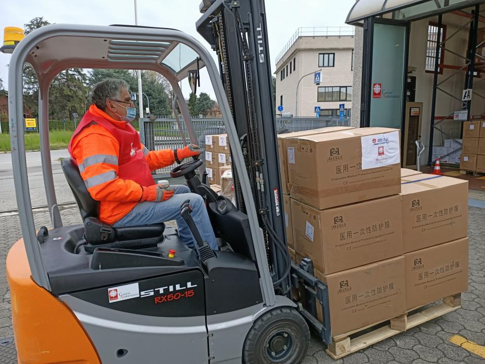 An operator wearing a face mask to protect himself against the spread of Covid-19 stacks boxes of medical supplies from Chinese charity Jinde Charities at the Italian charity Caritas Ambrosiana logistic center in Burago, in Monza Brianza, northern Italy, Wednesday, April 1, 2020. From tiny San Marino wedged next to two of Italy's hardest-hit provinces in the coronavirus outbreak to more economically powerful nations like Italy, countries are running up against export bans and seizures in the scramble for vital medical supplies. The new coronavirus causes mild or moderate symptoms for most people, but for some, especially older adults and people with existing health problems, it can cause more severe illness or death. (Caritas Ambrosiana via AP)