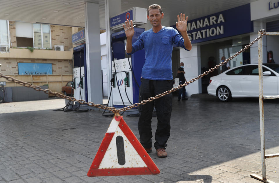 A gas station workers gestures as he saying no fuel at the station, in Beirut, Lebanon, Wednesday, July 29, 2020. Lebanon is hurtling toward a tipping point at an alarming speed, driven by financial ruin, collapsing institutions, hyperinflation and rapidly rising poverty _ with a pandemic on top of that. The collapse threatens to break a nation seen as a model of diversity and resilience in the Arab world. (AP Photo/Hussein Malla)