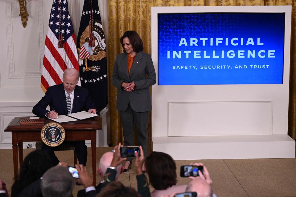 Vice President Kamala Harris looks on as President Joe Biden signs an executive order after delivering remarks on advancing the safe, secure, and trustworthy development and use of artificial intelligence, in the East Room of the White House in Washington, DC, on October 30, 2023.