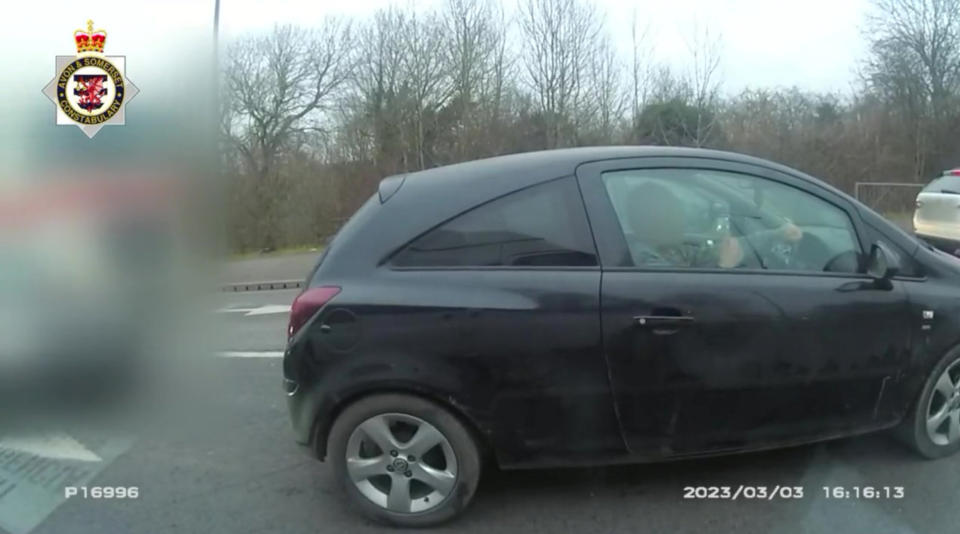 The driver did not realise that he was giving police officers the finger. (SWNS)