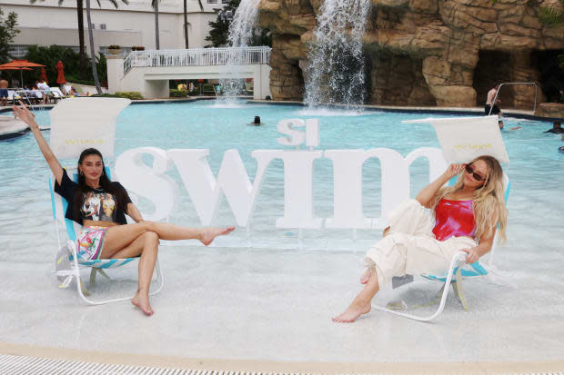 Nicole Williams English and Camille Kostek in Sunflow chairs.<p>Alberto Tamargo/Getty Images</p>