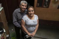 Fabio Rodolfo Vasquez and his wife, Maria Moreno, pose for photo in the home of Moreno's mother, in the San Pedrito neighborhood of Guatemala City, Thursday, Sept. 17, 2020. A homemade video where they dance to "Danger" by The Flirts went viral, and the couple, who met on the dance floor more than 30 years ago, became an overnight sensation. (AP Photo/Moises Castillo)