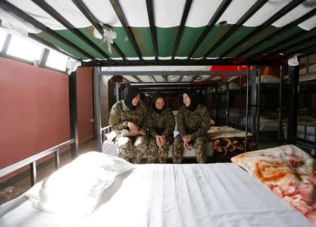 Female soldiers Zarmina Ahmadi, 22 (L), Adela Haidari, 23 (C), and Sabera, 21 (R), from the Afghan National Army (ANA) rest in their barracks at the Kabul Military Training Centre (KMTC) in Kabul, Afghanistan October 26, 2016. REUTERS/Mohammad Ismail