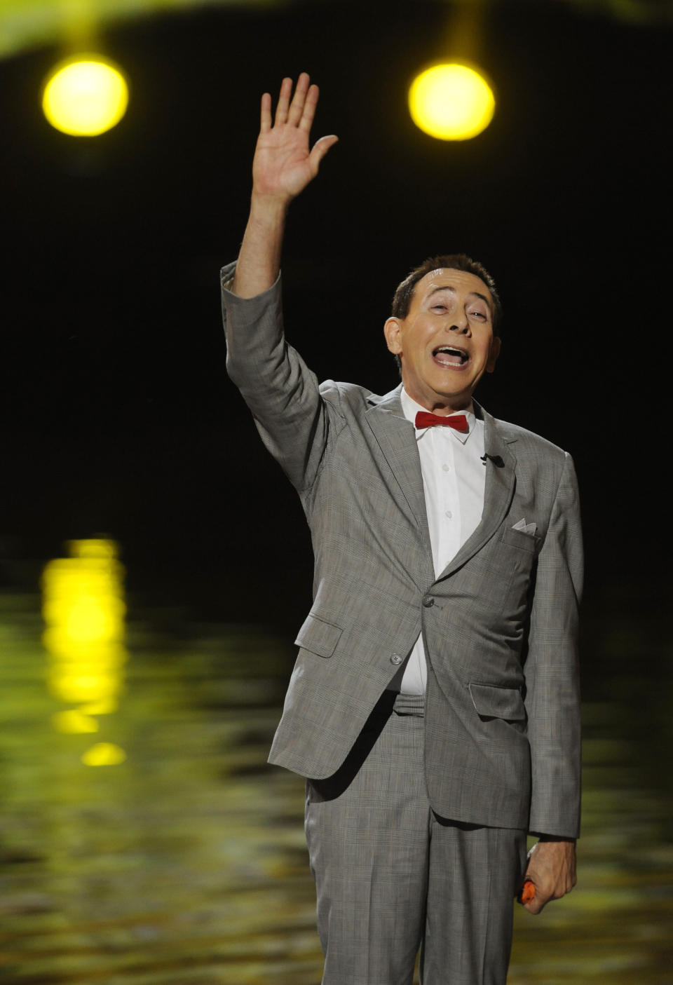 FILE - Paul Reubens, in character as Pee-wee Herman, waves to the crowd after receiving the Visionary Award at the 2011 Scream Awards, Saturday, Oct. 15, 2011, in Los Angeles. Reubens died Sunday night after a six-year struggle with cancer that he did not make public, his publicist said in a statement. (AP Photo/Chris Pizzello, File)