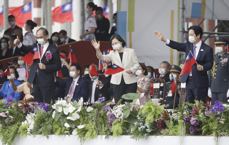 Taiwanese President Tsai Ing-wen, center, Vice President William Lai, right, and Speaker of the Legislature Yu Shyi-kun cheer with the audience during National Day celebrations in front of the Presidential Building in Taipei, Taiwan, Monday, Oct. 10, 2022. (AP Photo/Chiang Ying-ying)