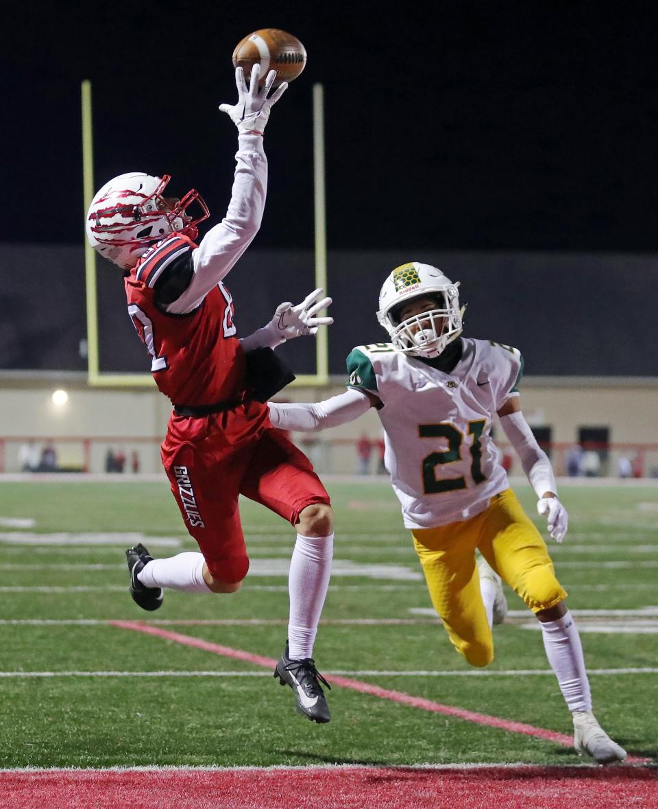 Wadsworth wide receiver Caden Shriver, left, catches a touchdown over Medina cornerback Aedyn Ruiz during a Division I regional quarterfinal Friday in Wadsworth.