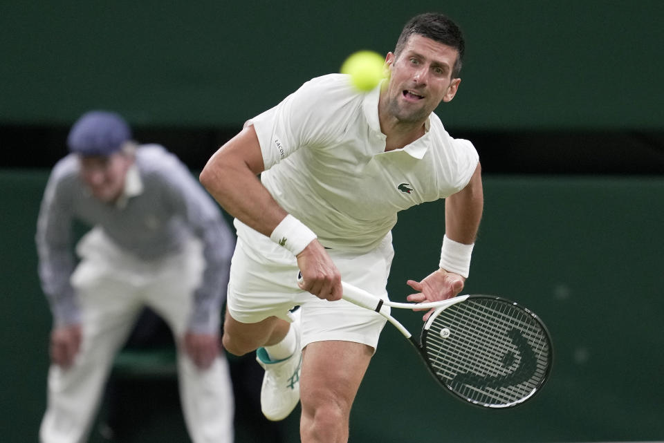 Serbia's Novak Djokovic serves to Switzerland's Stan Wawrinka in a men's singles match on day five of the Wimbledon tennis championships in London, Friday, July 7, 2023. (AP Photo/Kin Cheung)