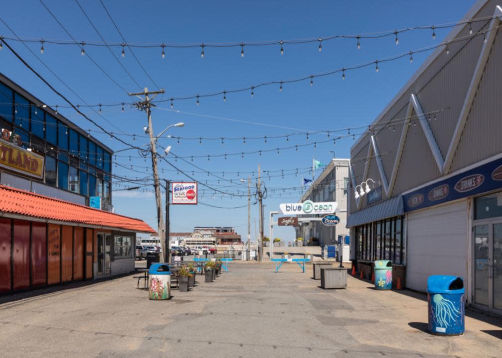 A beach promenade with low buildings on both sides. 