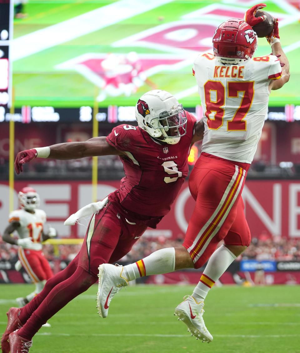 Sep 11, 2022; Glendale, Arizona, United States; Kansas City Chiefs tight end Travis Kelce (87) catches a touchdown over Arizona Cardinals defender Isaiah Simmons (9) at State Farm Stadium.
