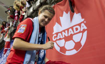 VANCOUVER, CANADA - JANUARY 29: Christine Sinclair #12 of Canada signs autographs for fans after the championship game of the 2012 CONCACAF Women's Olympic Qualifying Tournament against the United Sates at BC Place on January 29, 2012 in Vancouver, British Columbia, Canada. (Photo by Rich Lam/Getty Images)