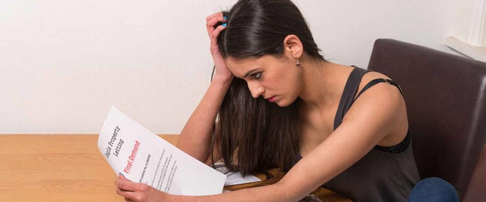 young student worried over un-paid bills and student loan