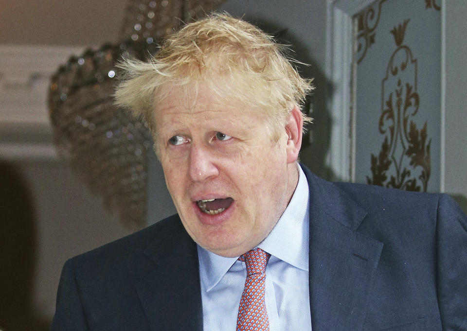 Conservative party leadership contender Boris Johnson leaves his home in London, Monday June 17, 2019. Candidates seeking to beat Boris Johnson and become Britain's next prime minister accused the Brexit-backing front runner of trying to avoid scrutiny after he refused to take part in a televised debate alongside his five rivals Sunday. (Jonathan Brady/PA via AP)