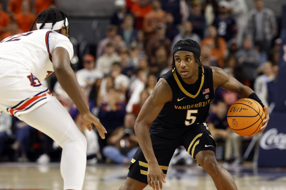 Vanderbilt guard Ezra Manjon (5) brings the ball down court as Auburn guard Denver Jones (12) defends during the first half of an NCAA college basketball game, Wednesday, Jan. 31, 2024, in Auburn, Ala. (AP Photo/Butch Dill)