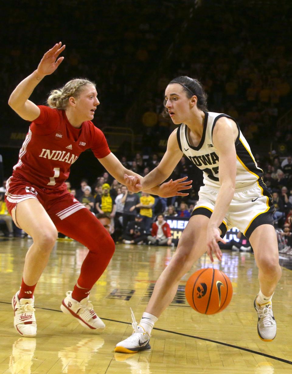 Iowa’s Caitlin Clark (22) drives toward the basket defended by Indiana’s Lexus Bargesser (1) Saturday, Jan. 13, 2024 at Carver-Hawkeye Arena in Iowa City, Iowa.