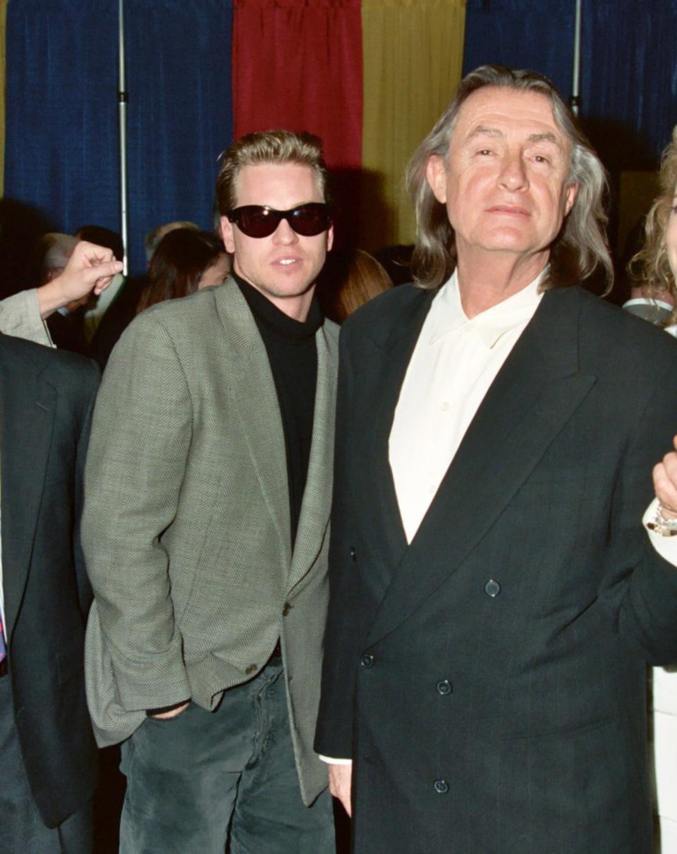 Val Kilmer and Joel Schumacher posing for a photo