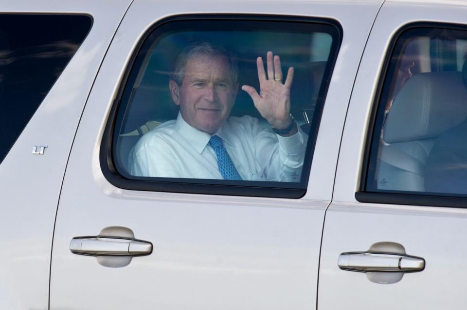 Former president George W. Bush waves to a crowd of about 20 onlookers Monday, Feb. 3, 2014, at the Vero Beach Municipal Airport, where he arrived ahead of his speaking engagements at the Riverside Theatre. The 43rd president was the headliner for Riverside's Distinguished Lecturer Series in 2014.