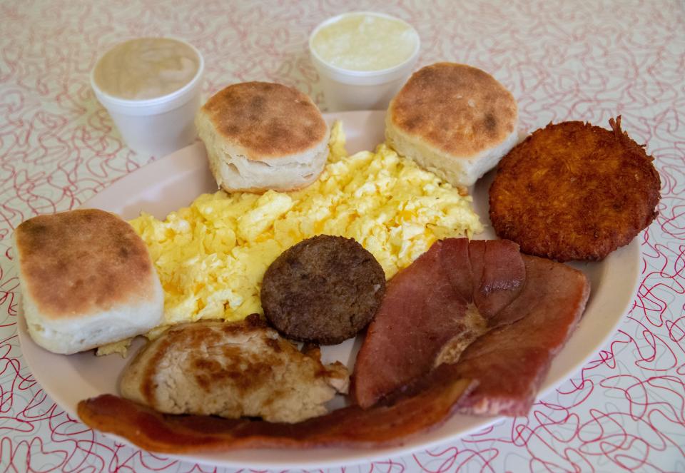 The Sampler at Bryant's Breakfast includes three eggs, bacon, sausage, country ham, a pork tenderloin, biscuits, gravy, grits and a potato patty.