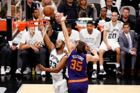 San Antonio Spurs center Boris Diaw (33) shoots the ball as Phoenix Suns power forward Mirza Teletovic (35) defends during the first half at AT&T Center. Mandatory Credit: Soobum Im-USA TODAY Sports