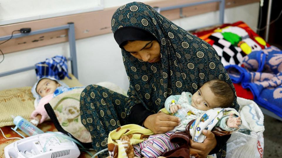 PHOTO: Palestinian Wafaa Tabasi holds her twin malnourished daughters at al-Awda health center in Rafah in the southern Gaza Strip, Mar. 12, 2024.  (Mohammed Salem/Reuters)