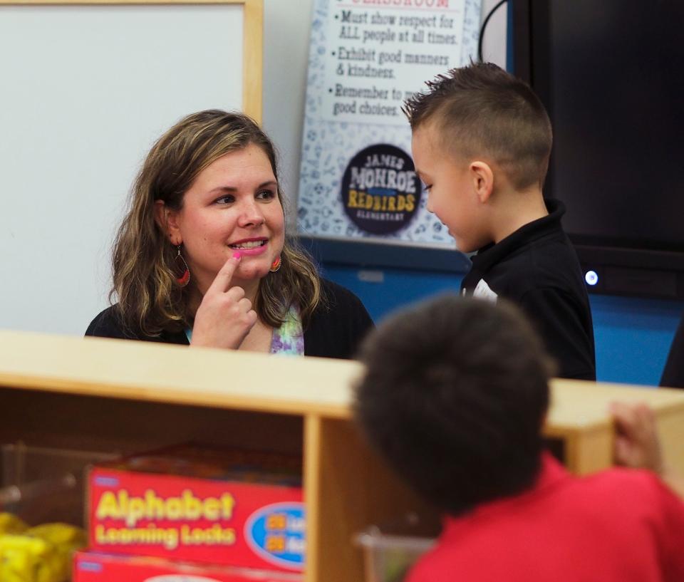 Pre-K teacher Ashton Gonzalez sings an alphabet song with students during the first day of school Thursday, Aug. 11, 2022, at Monroe Elementary School.