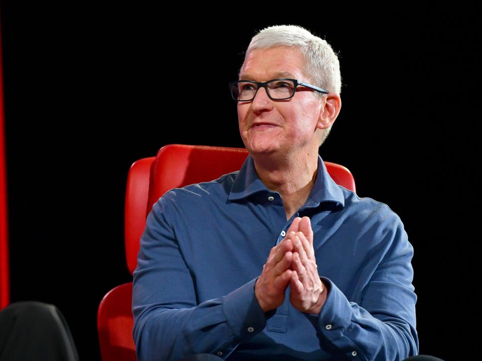 Tim Cook Apple sitting on a red chair