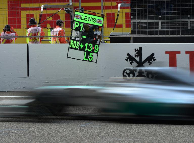 Mercedes AMG Petronas driver Lewis Hamilton passes by his pit area before winning the Formula One Chinese Grand Prix, in Shanghai, on April 20, 2014