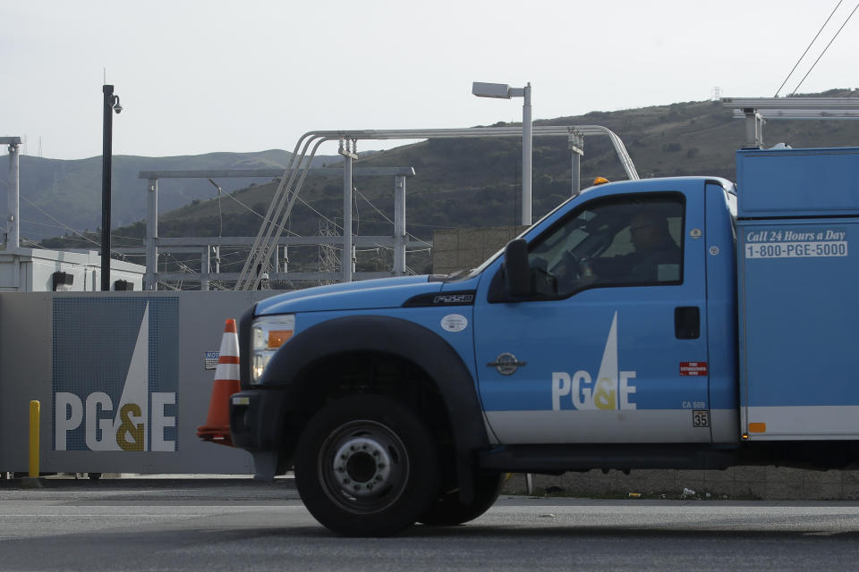 FILE - In this Feb 20, 2020, file photo, a Pacific Gas and Electric truck drives past a PG&E location in San Francisco. A California prosecutor has charged troubled Pacific Gas & Electric with starting a 2019 wildfire. The Sonoma County District Attorney on Tuesday April 6, 2021, charged the utility in the October 2019 Kincade Fire north of San Francisco. (AP Photo/Jeff Chiu, File)