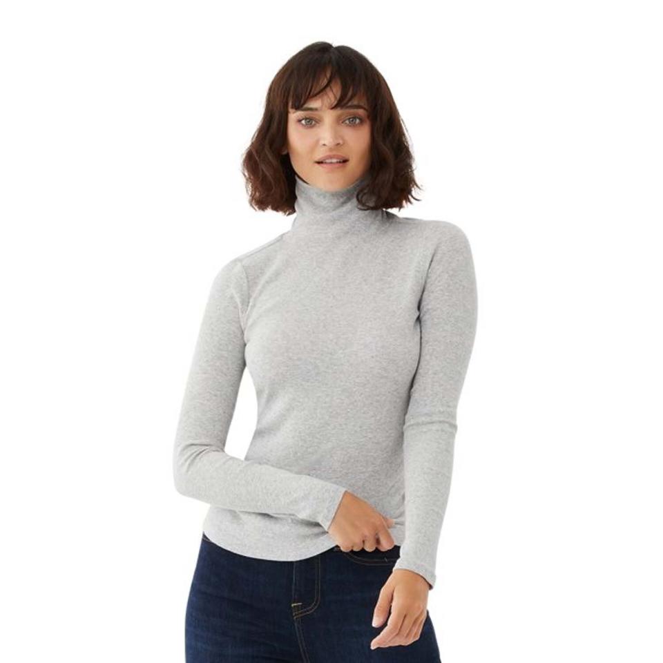 woman wearing gray heather turtleneck sweater and blue jeans